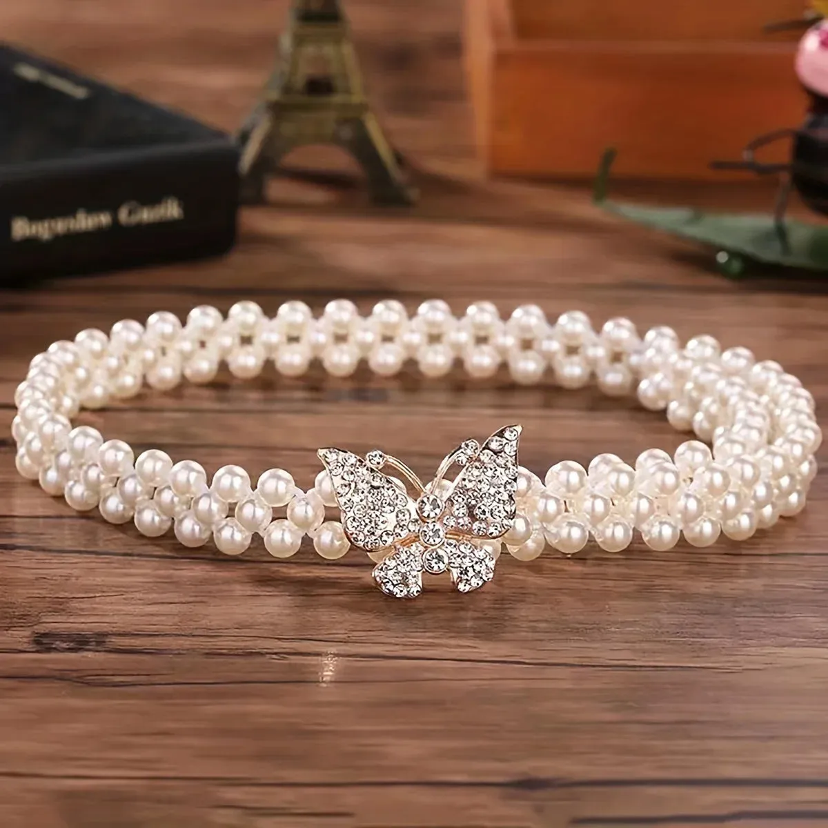 Ceinture élastique raffinée agrémentée de Perles nacrées et d'une boucle Papillon en strass (extensible de 70 à 85 cm)